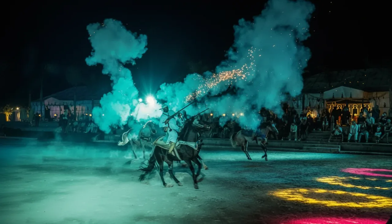 Moroccan Fantasia riders on horseback charging with rifles