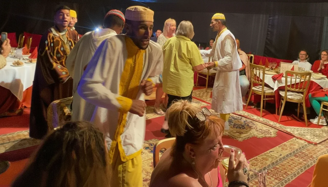 Snake charmer entertaining guests during a Berber night