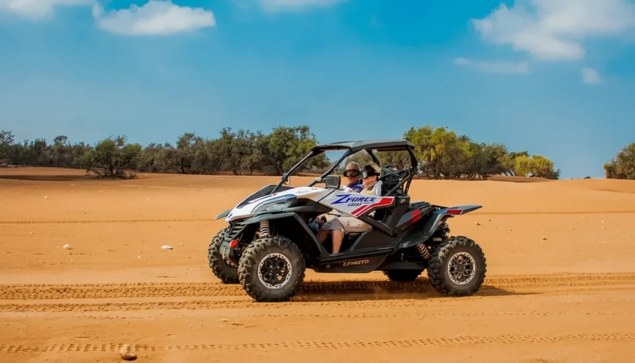 Action shot of a buggy kicking up sand in the Moroccan desert